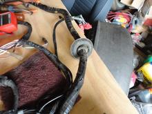 The used harness purchased had this grommet that was missing on the original. The grommet fits where the harness passes from the foot well into the space between the inner fender well. I believe that the wiring harness chaffed through from rubbing against the hole in the inner fender well because the grommet was missing.  At some point in the car's history, the right front fender was replaced.  Not sure why the grommet was missing. 