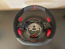 Guardian wheel, heated flat bottom, alcantara sides and perforated leather top and bottom. Extended Ferrari red paddles and accents.