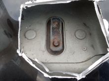 in close-up you can see the back side of the "retaining catch assembly".  if you can cut within the outer retaining studs you will be able to replace the assembly with a replacement