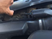 lightly lifting the cover with the tip of my thumb