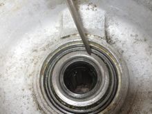 Bearing fully drifted into place. It is the space bewteen the bearing (pointer on it) and the hub tube (inside the bearing below it) that the spacer is requied for