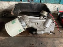 Oil filter housing with screw on filter modification.