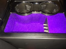 When the blabk interior was ordered the glove box, center console storage and rear armrest storage was lined in the "electric" purple fabric.