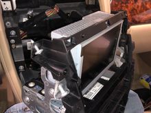 2 small, T20 at the top followed by 4,  T27 screws. You will have to remove a trim clip at the top and the unit will slide out