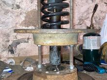 Turn the nuts on the threaded rods so that they push the rotors away from each other.