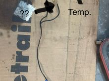 This is the other mystery connection. The wire is green with a brown stripe. It is harnessed together with the instrument panel temperature gauge wire. 