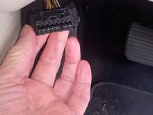This is what the OBD11 port looks like, I believe it should be in the foot-well