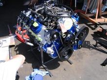 Now, with the engine and all of its ancillary parts from Turnkey, we were ready to begin the process of putting the drive train in the car.  Here is the engine after we installed the wiring harness, plugs, wires, accessories, motor mounts, and everything else to prepare it for the chassis.