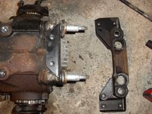 The support bracket on my 1998 convertible.  The second parts diagram in your post looks like they modified this part and did away with the washers.
