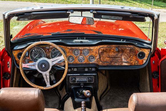 This was the interior of my 73 Triumph. People used to joke with me that it was a little Jaguar-ish with the leather seat covers, Burled walnut dash, door caps, and matching wood rimmed wheel!
