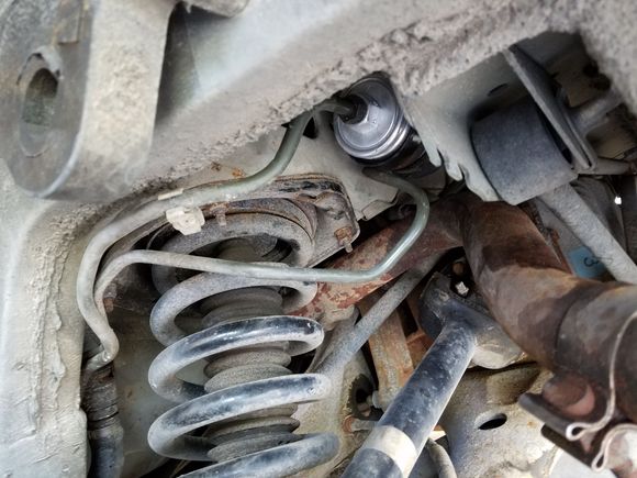 That metal line going under the filter. (Was wondering if it went over the filter originally)