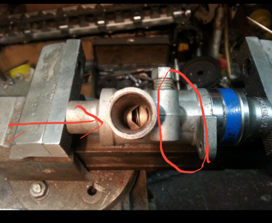 Piston down (out of site) being pushed down by spring to the bottom of the cylinder.