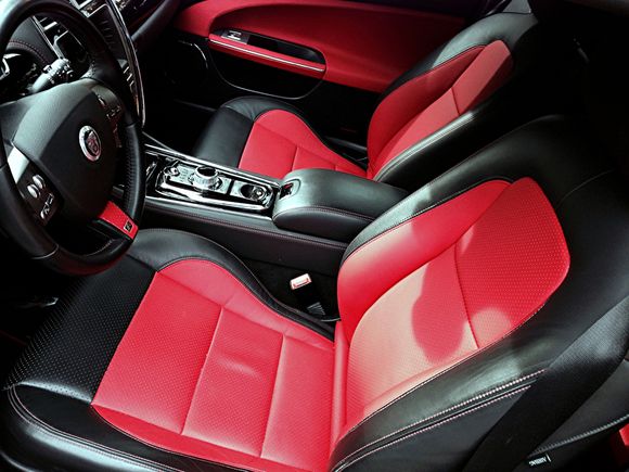 added Red leather inserts, doors, seats, and bottom of steering wheel