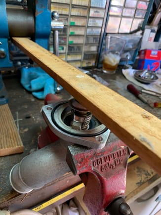 Closeup of the 3ft piece of hardwood that I used to compress the thermostat. Needle nose plyers are good for maneuvering the wings in place.