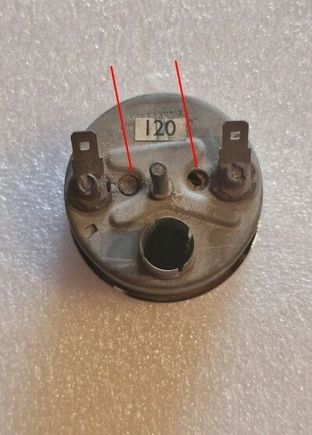 The two corks on the back of the gauge. You may have to remove the bracket to access them.
