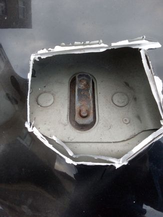 in close-up you can see the back side of the "retaining catch assembly".  if you can cut within the outer retaining studs you will be able to replace the assembly with a replacement