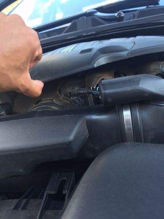 lightly lifting the cover with the tip of my thumb