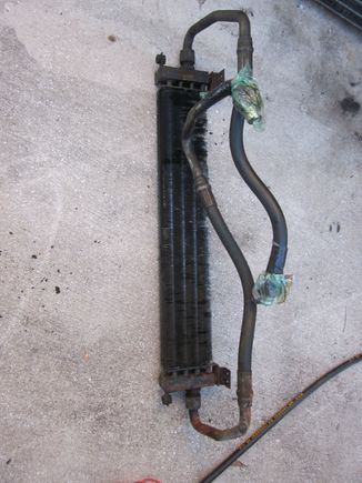 Engine Oil cooler, no leaks, 90% of the fins are in good shape, some are missing on lower right side. No damage to hoses or fittings