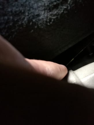 your hand can fit between there from passenger (us cars) side of the vehicle.