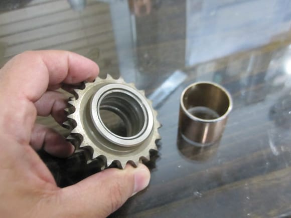 Idler sprocket and the new bearing. The old bearing has some scars on it