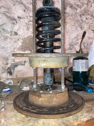 Turn the nuts on the threaded rods so that they push the rotors away from each other.