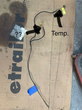 This is the other mystery connection. The wire is green with a brown stripe. It is harnessed together with the instrument panel temperature gauge wire. 