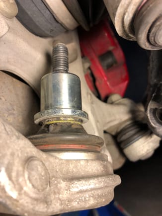 How to remove this silver cynlindrical piece from the ball joint? 