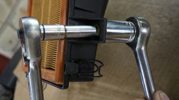 After it is broken into two, it can be screwed off with a socket - same applies to the other part stuck in the car-body.