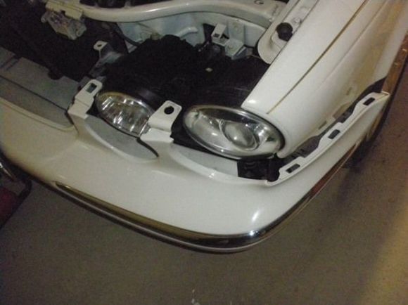 Bumper cover in position to remove Headlamp.