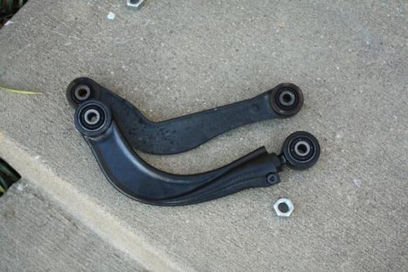 What the arms look like after the required modification.  The modification is nothing more than removing the locking nut and then screwing the adjustable mount in as far as it will go along with the adjuster.  The nut that I removed is sitting below and to the right of the new arm, near where it was removed from.