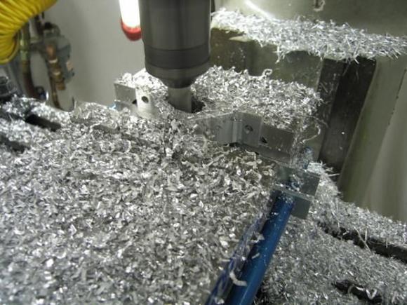 Next, it is time to start shaping the bracket  some creative clamping is sometimes needed to keep from flinging the piece across the garage (ask me how I know that!!).  Then some lightening slots to keep it from weighing the back of the car down: