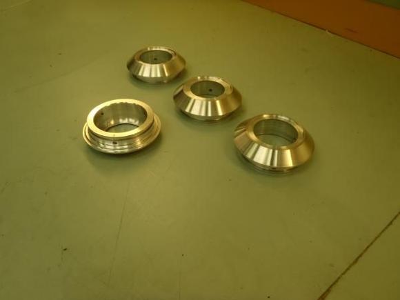 the next step in the process was to replace the "growler" center caps on the wheels.  A long afternoon at the lathe, and i had a new set of center caps complete with set screws for locking them to the wheel and a carefully recessed face that would accept the new Lister badges.
