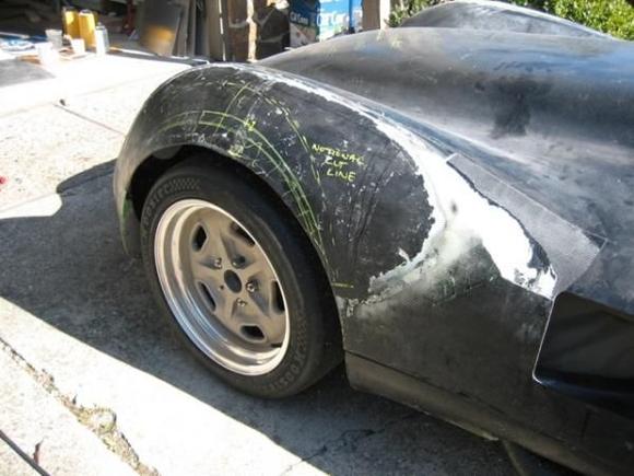 4
Next, we removed all of the bondo and started laying out the cut lines required to maximize tire clearance for the much wider wheels and tires.
