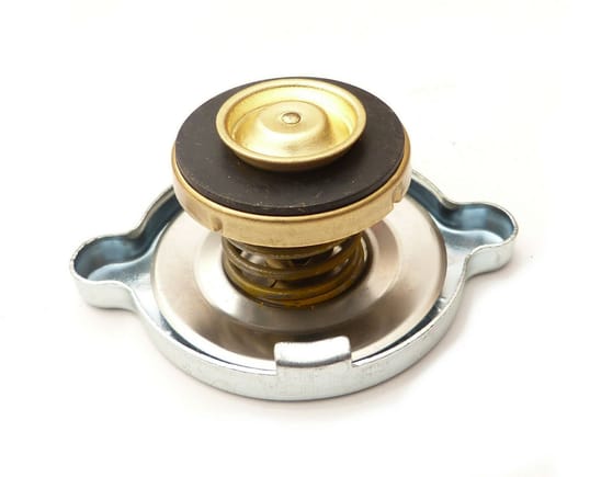 Radiator cap with plunger and spring.