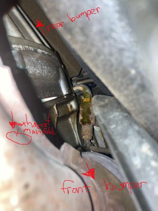 Laying down on my back looking up. Left hand side of the car. Right above the exhaust. Any one know what it is? Is that even coolant or green mineral oil for power steering?
