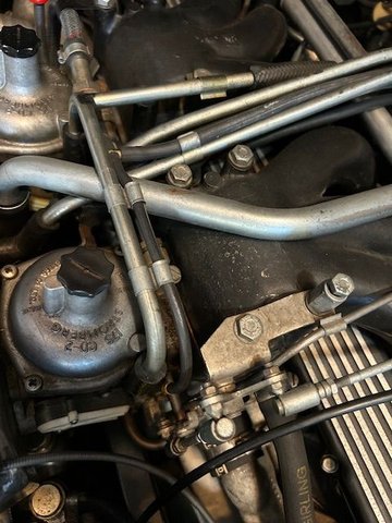 Intake pipe from air box to gulp valve. Note air injection pipe crossing over the top of intake pipe and dropping down to rubber connectors behind carbs.