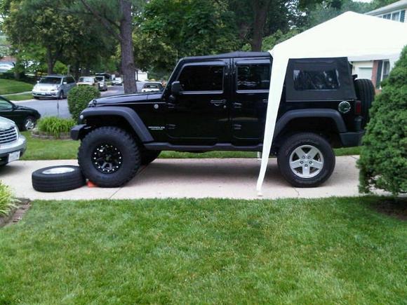 Relatively mid-lift.  Most of the lift is on and this is the tire change-out.  I didn't really have much time to take many during-lift pics since it was raining most of the time and I just wanted to get it done before the kids birthday party.