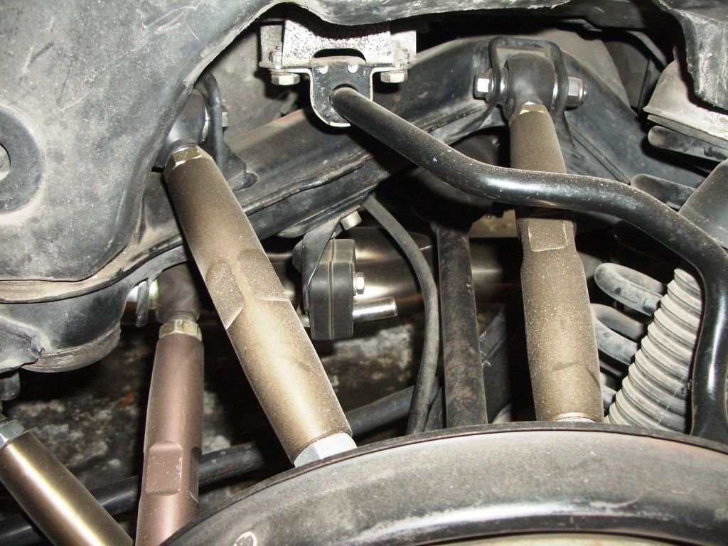 You can sort of see the resonator eliminator through the heim joints.  It's the shiny thing.