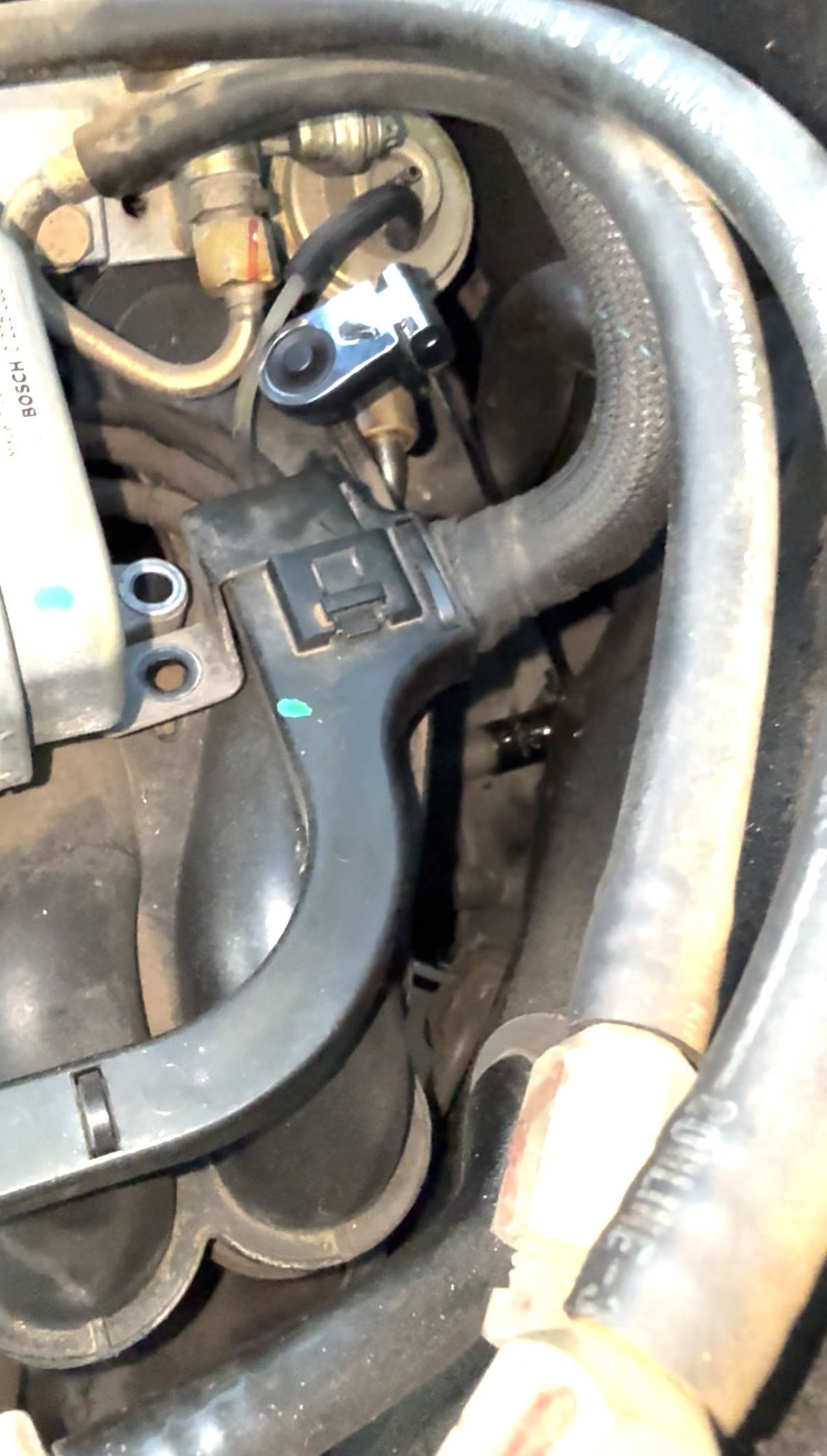The handy life saving tool I used to crank the top bolt loose. A long swivel head ratchet wrench. 3/8 with a 17mm socket. Use a pipe to get leverage.. pull back those fuel lines to get space.