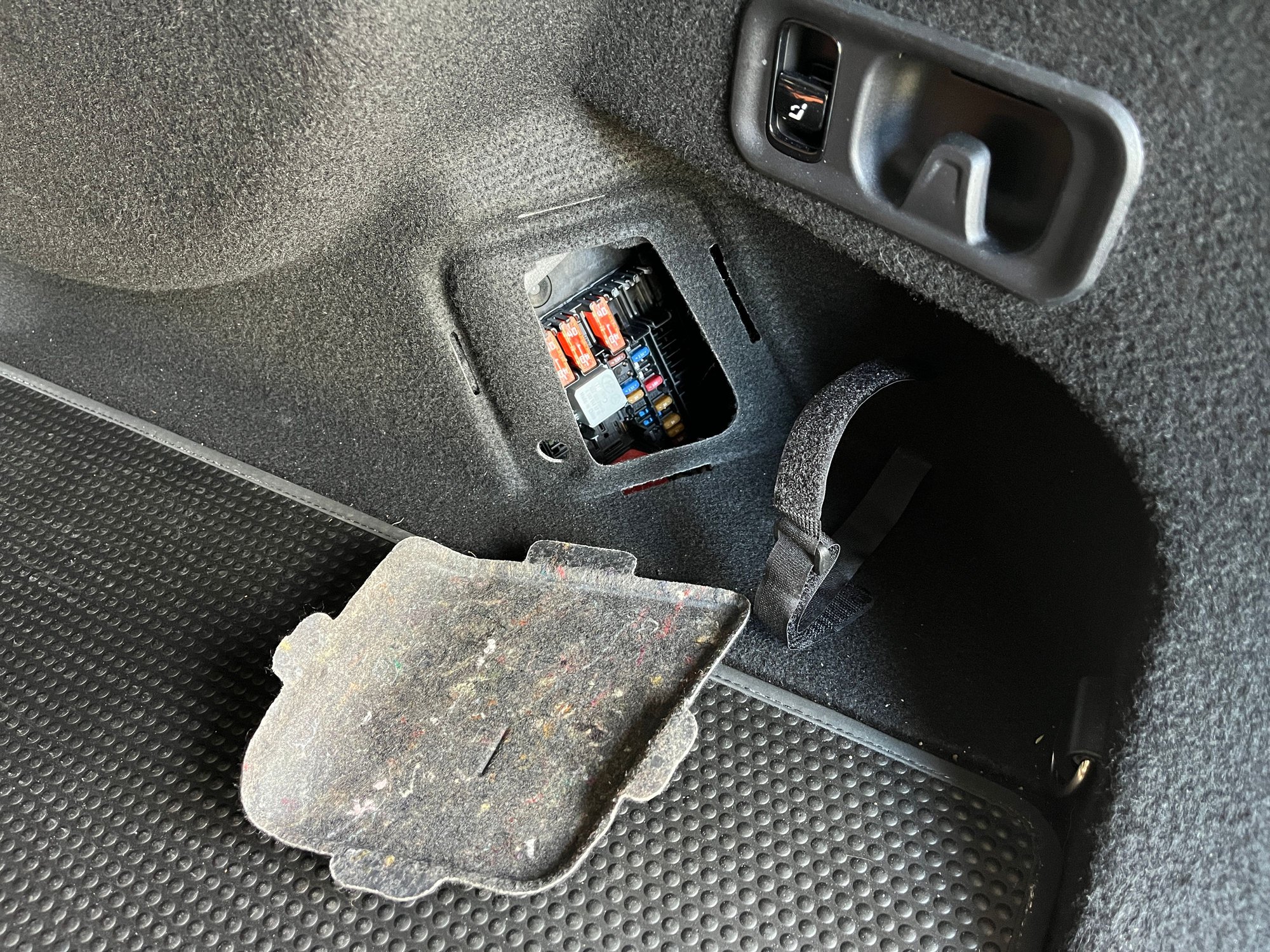 Shroud tucked behind trunk liner.