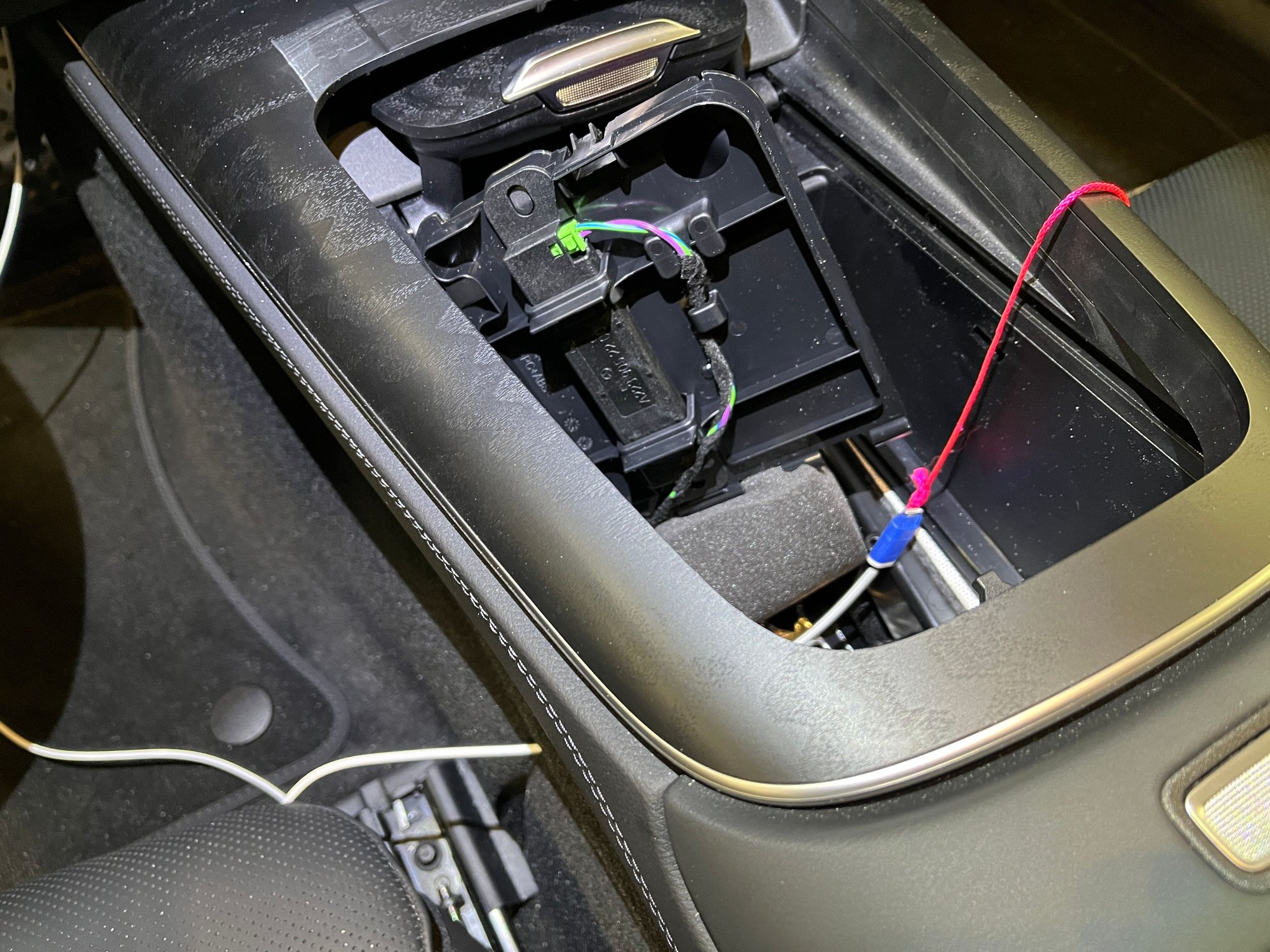 Snaking cable into cup holder compartment.