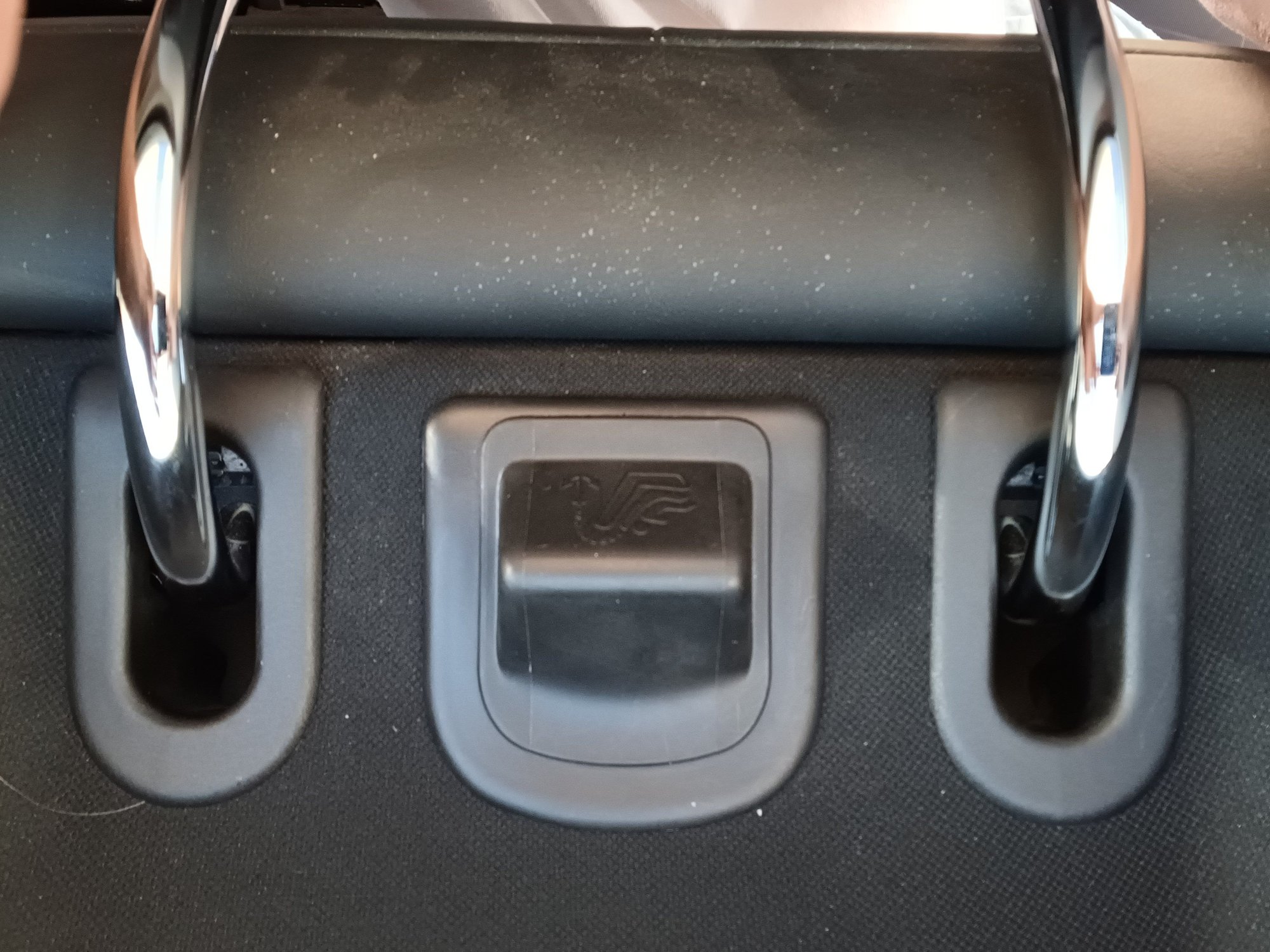 Base of left outside rear headrest. Center and right are identical.