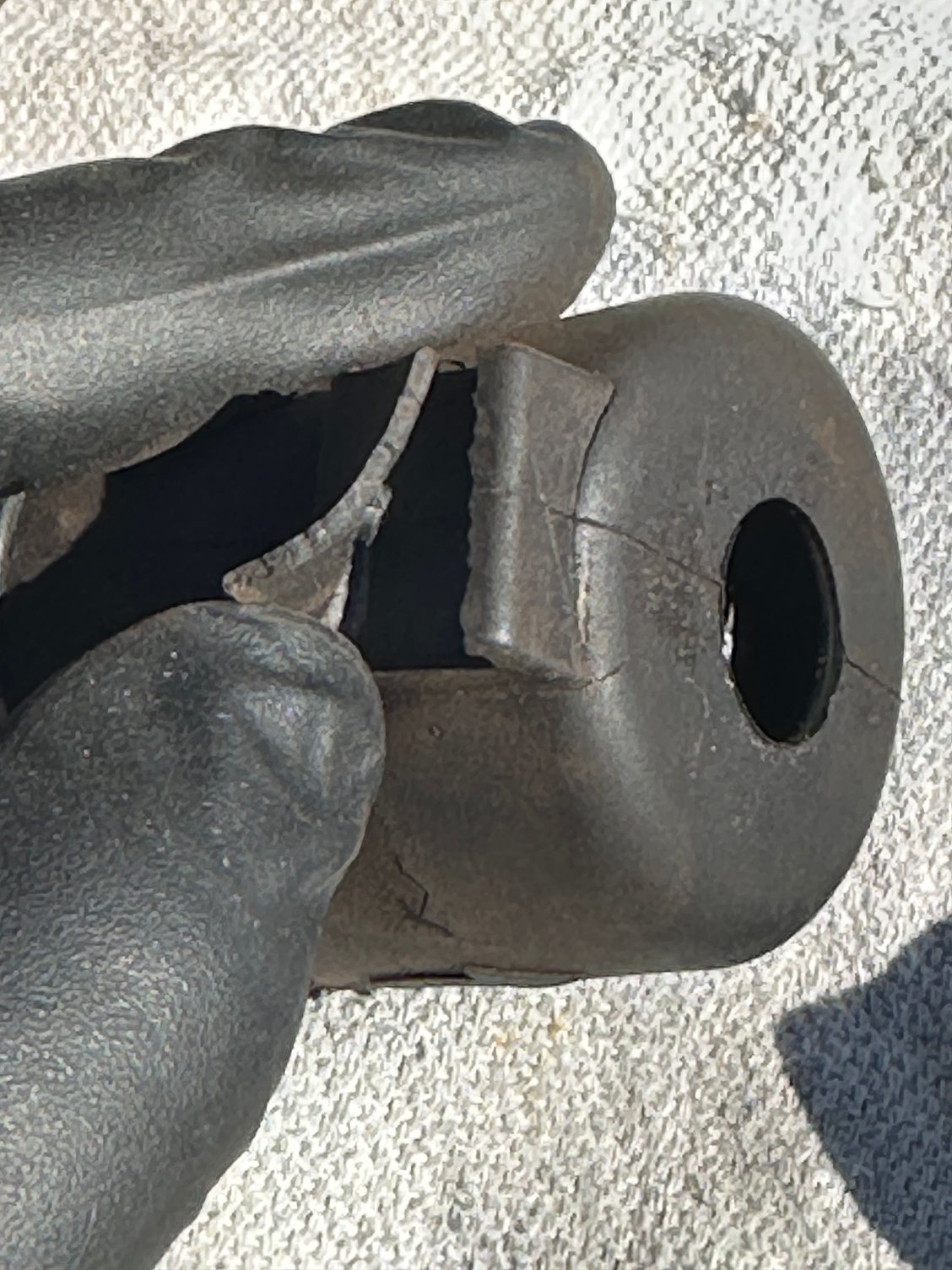 Note the rough condition of the rubber boot, including a ripped slot where it is held behind the bumper.  This is on a car with only 28,000 miles on the odometer.