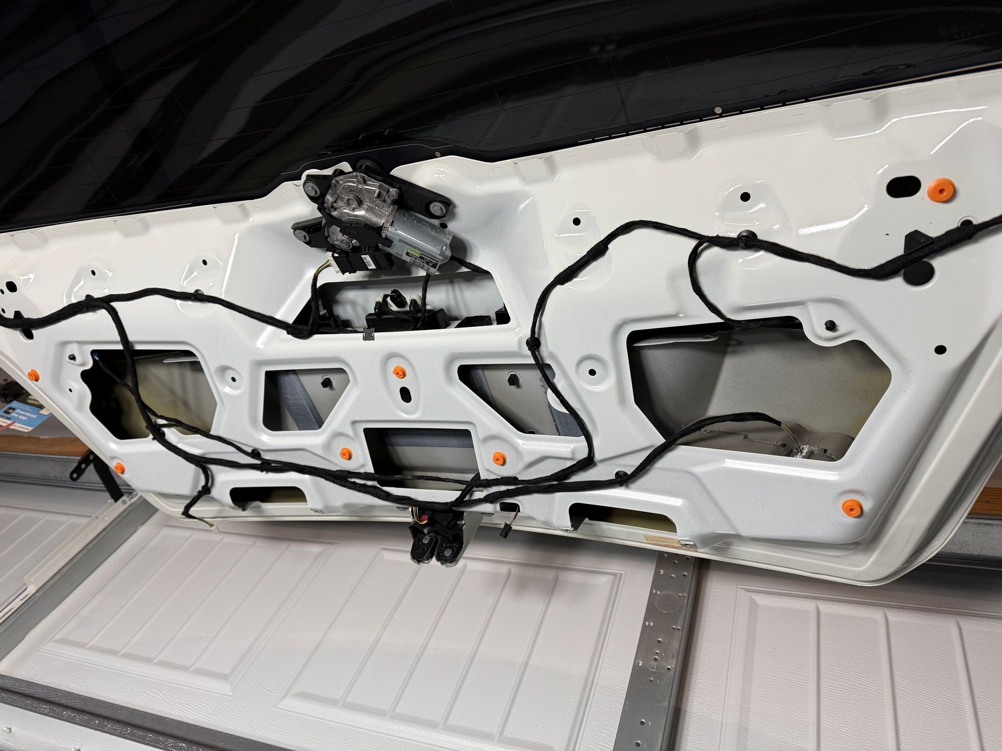 After the rear panels� 17 orange fasteners have been pried off this is what you see for the rear trunk interior. 