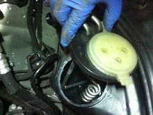 Reattach the washer fluid tank onto its mounting post.  Reinsert the heating coils into the washer fluid tank.  Make sure the cap and lines are aligned as they were before.