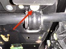  Next, you’ll loosen the seat bottom to move it out of the way, but you won’t console try detach it since it’s not necessary. It’s only held on by two screws under the front part of the seat, hidden by the storage bin you just removed. Here’s one of the screws. It’s attached to a C-clamp that wraps around a horizontal rod. It’s really easy to see when you remove the storage bin 