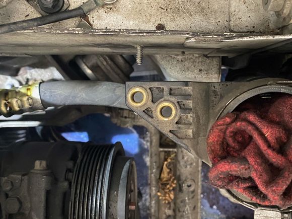 The bracket holding the front box of the supercharger. 