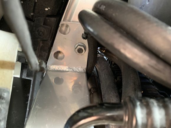 Left/Drivers side straight up at H/E mounting tab