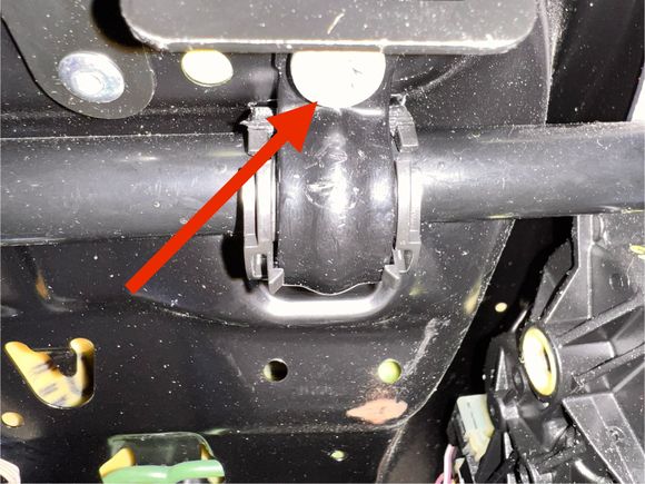  Next, you’ll loosen the seat bottom to move it out of the way, but you won’t console try detach it since it’s not necessary. It’s only held on by two screws under the front part of the seat, hidden by the storage bin you just removed. Here’s one of the screws. It’s attached to a C-clamp that wraps around a horizontal rod. It’s really easy to see when you remove the storage bin 