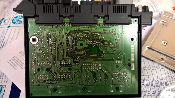 Remove the 5 T10 bolts and backing plate to expose the circuit board.